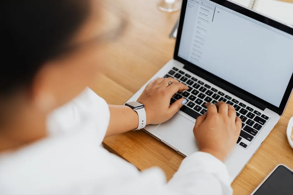 Hands on a laptop, the graded audit arriving by email