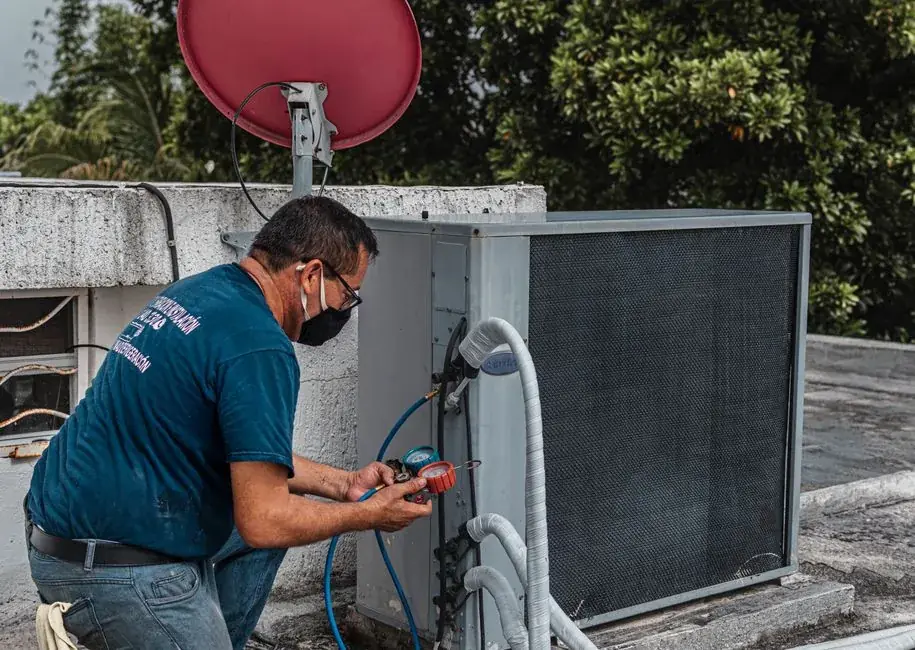 HVAC technician checking a rooftop air conditioning unit