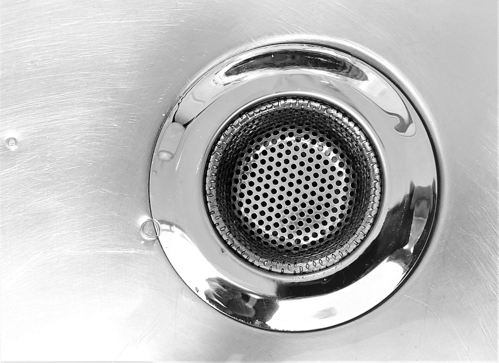 A clear sink drain after cleaning