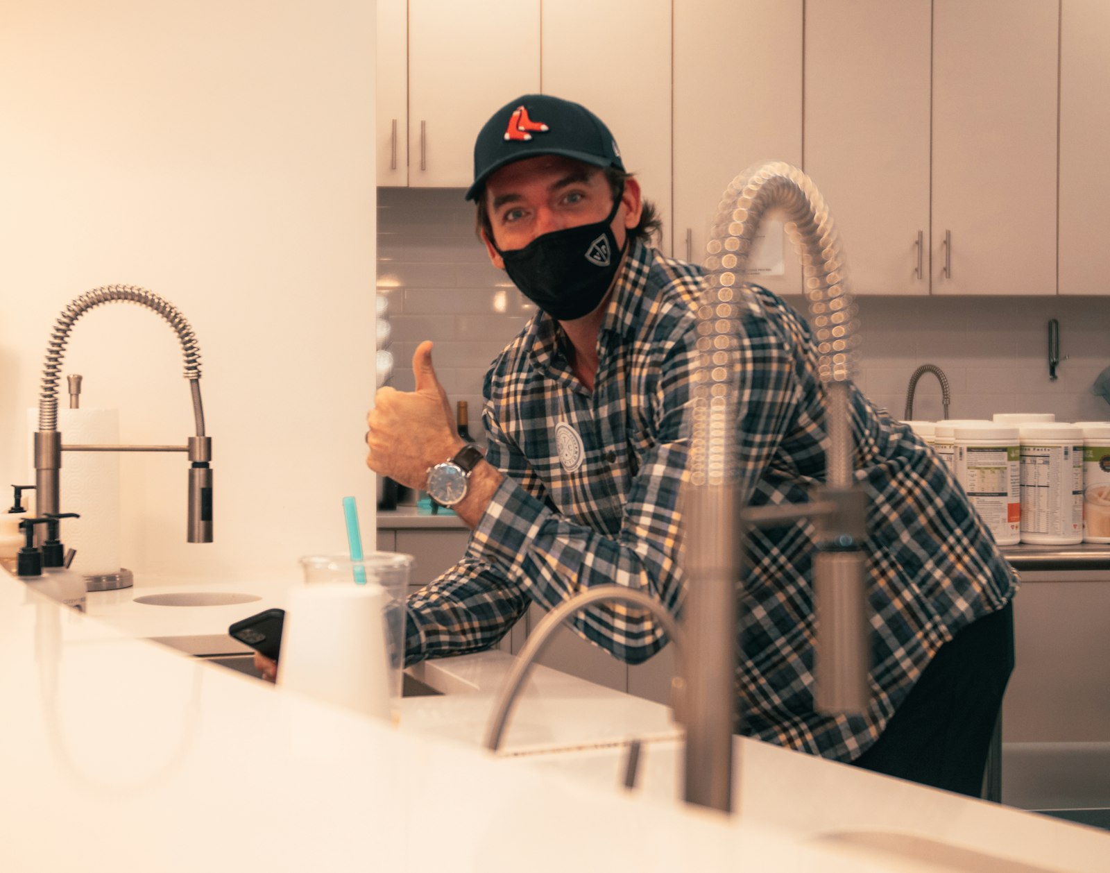 A plumber clearing a kitchen sink drain